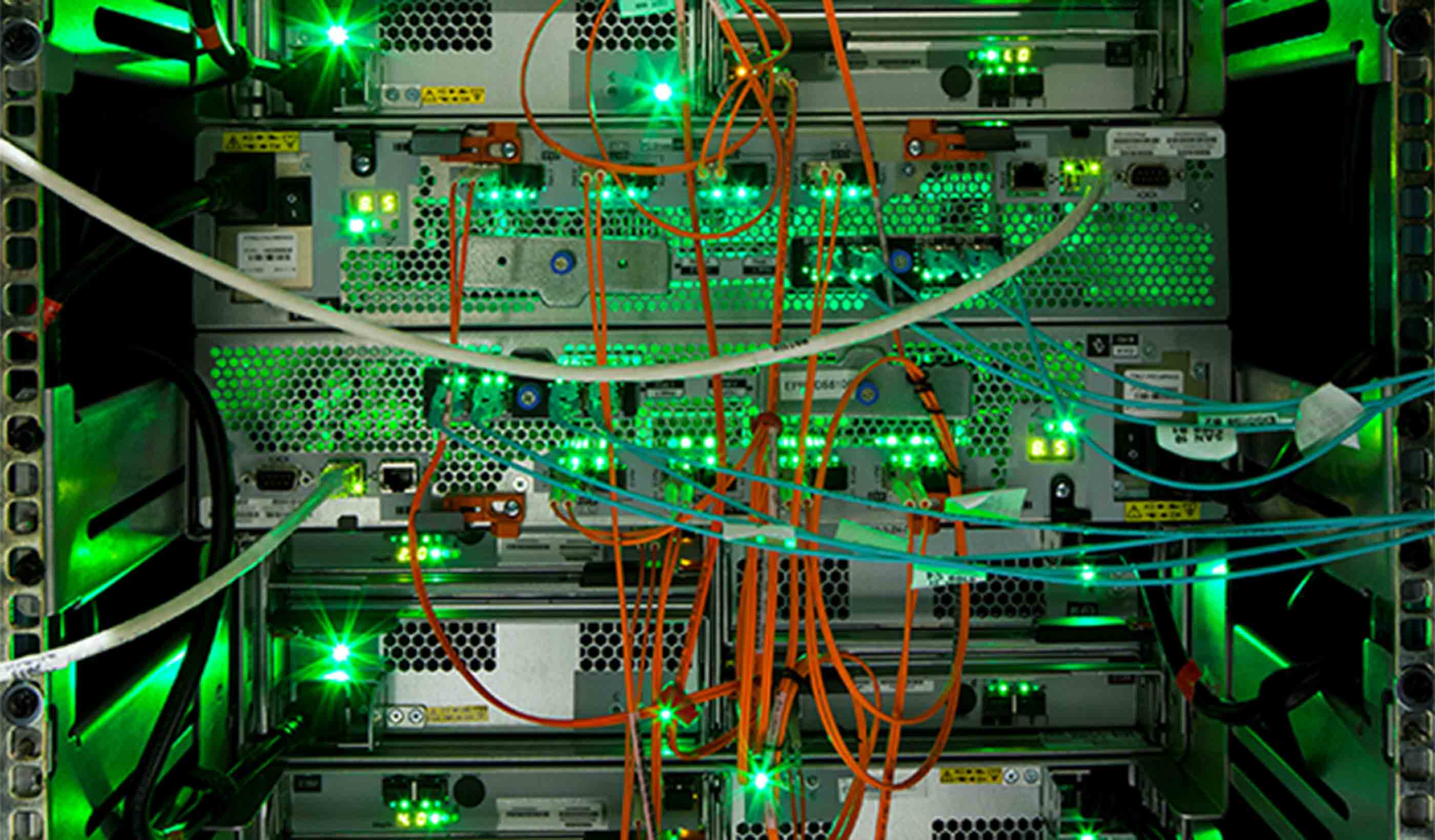Rows of glowing server racks in a modern Canadian data center with blue ambient lighting