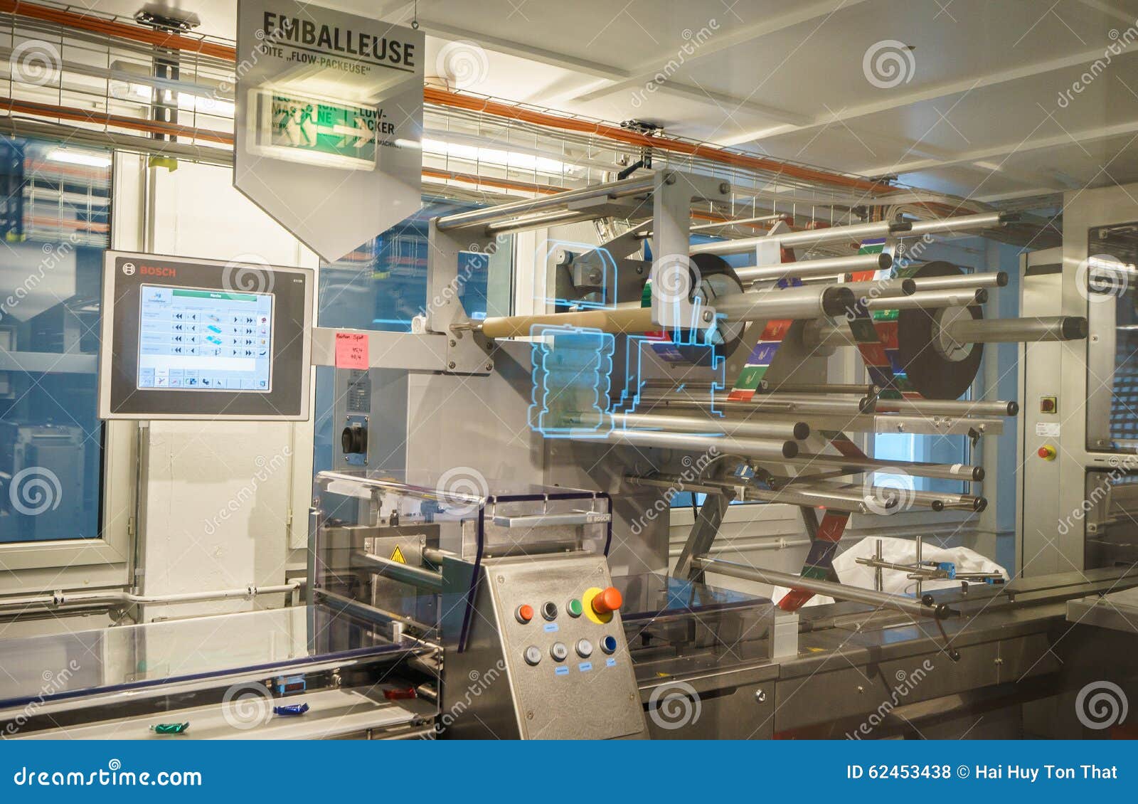 Factory workers on an assembly line packaging Nestle chocolate bars in a British production facility