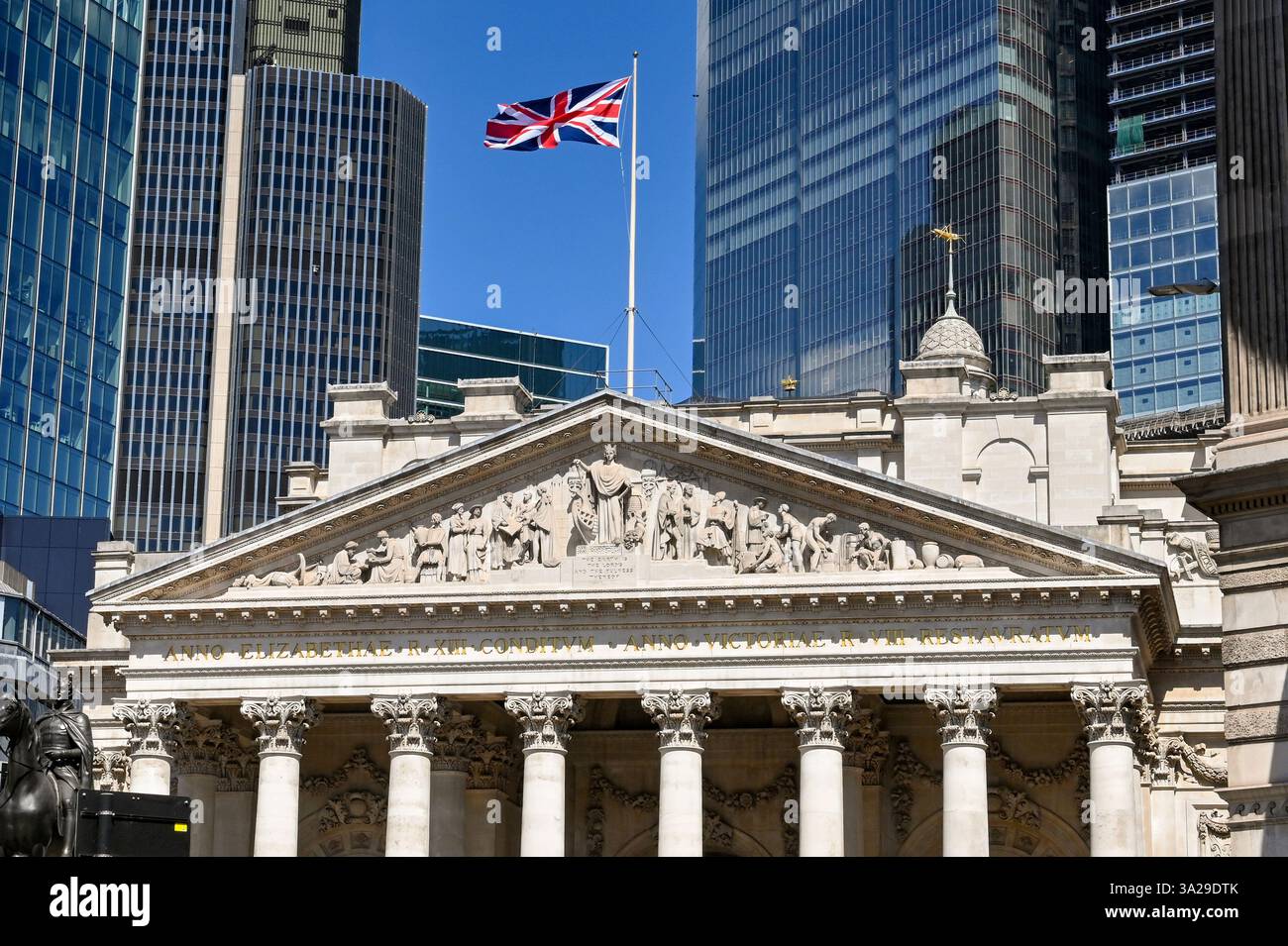The iconic facade of the London Stock Exchange building with bustling financial district activity in the background